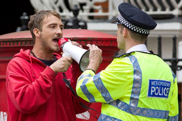 A police officer remonstrates with a protester on a street during a demonstration in London. 18.08.2014