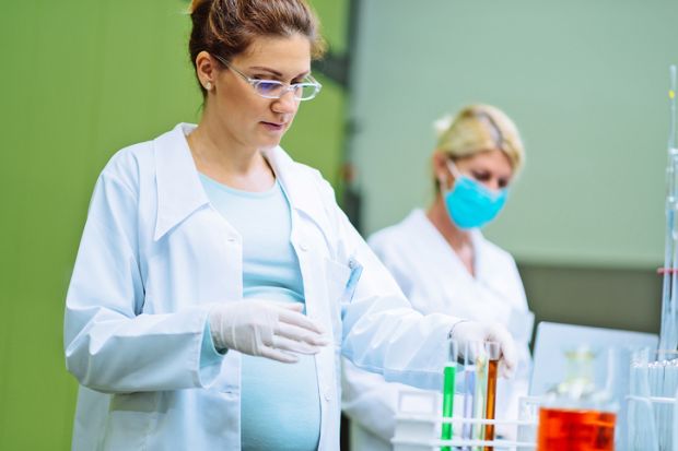 Pregnant woman doing lab work