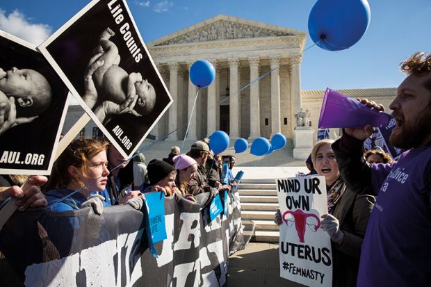 pro choice advocates (right) and anti abortion advocates (left) rally outside of the supreme court