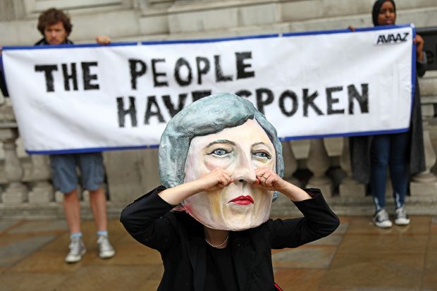 Protester in Theresa May mask