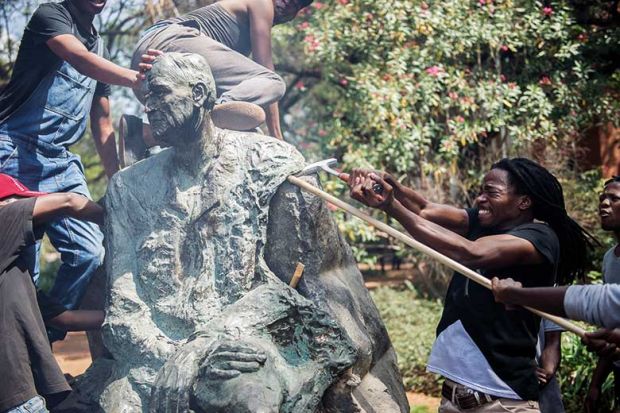 Protesters attacking statue