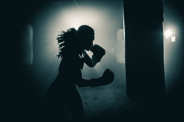 A woman punches a punchbag