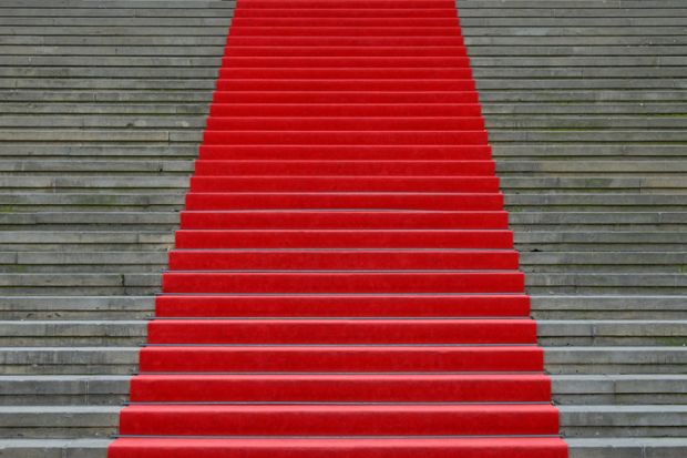 A red carpet up stairs