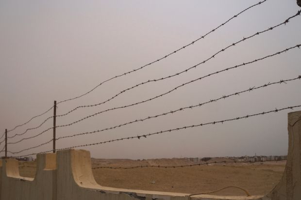 Restrictive fence with barbed wire