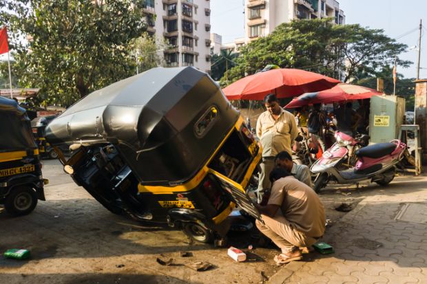A rickshaw wheel is repaired