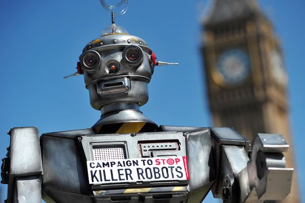 A robot wearing a sign saying 'Campaign to Stop Killer Robots’