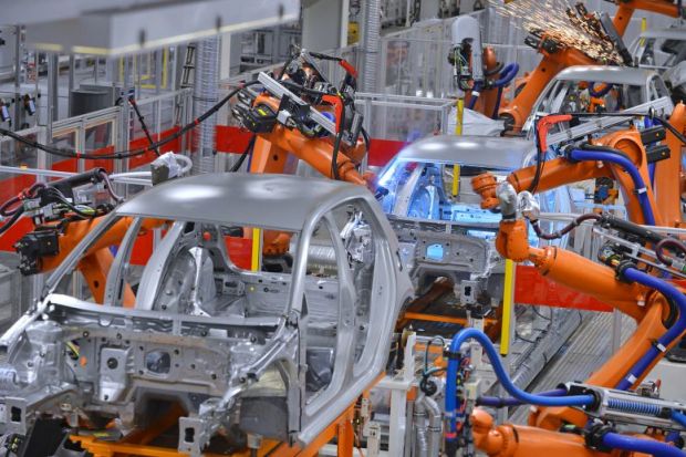 Robots welding in factory