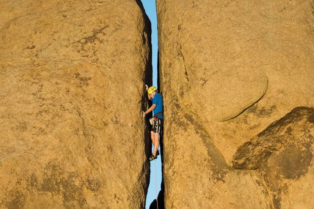 Rock climbing narrow crevice
