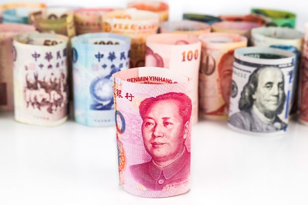 Rolled-up bank notes with Chinese currency at front
