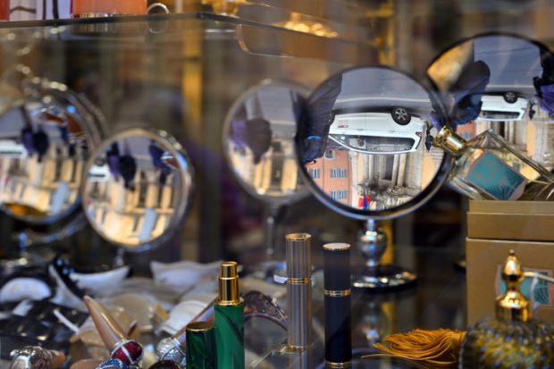 Rome, Italy - February 17, 2022 Reflection in the windows of the small store in Rome, Italy