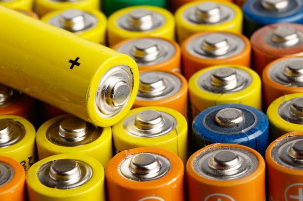 Rows of multi-coloured AA batteries