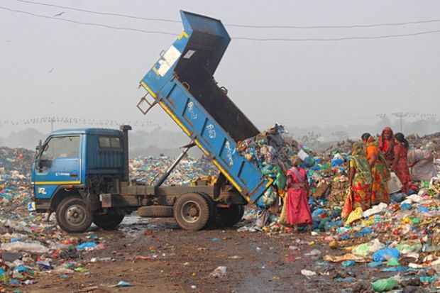 Poor people in a rubbish dump