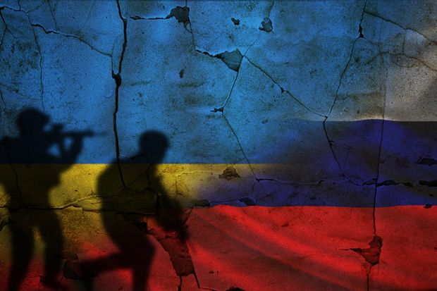 Russian and Ukrainian flags with shadows of soldiers