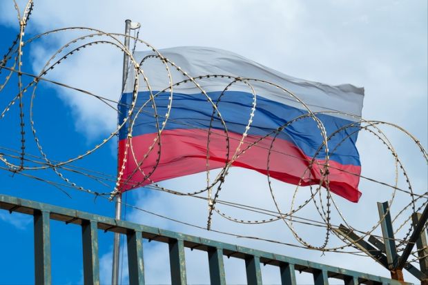 The Russian flag behind barbed wire The Russian flag behind barbed wire