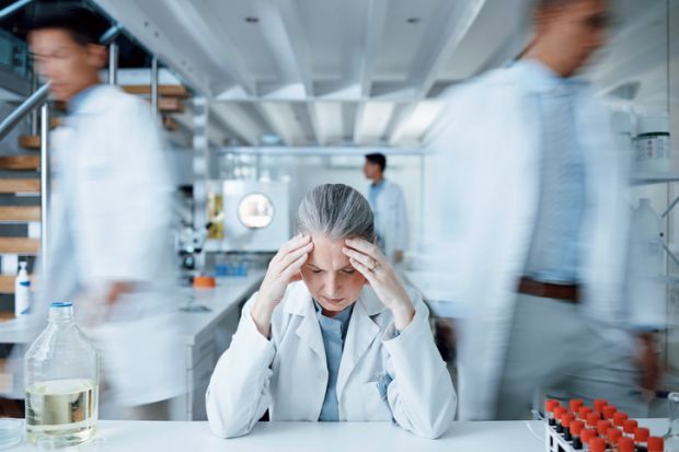 A worried scientist in a lab, symbolising research culture