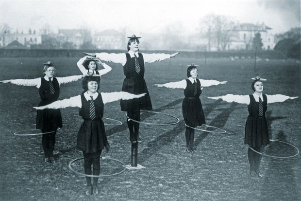 schoolgirls balancing a ball and plate on their heads while spinning a hoop schoolgirls balancing a ball and plate on their heads while spinning a hoop