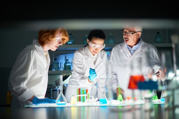 Scientists with liquids of various colours in test tubes, symbolising policy options Scientists with liquids of various colours in test tubes, symbolising policy options
