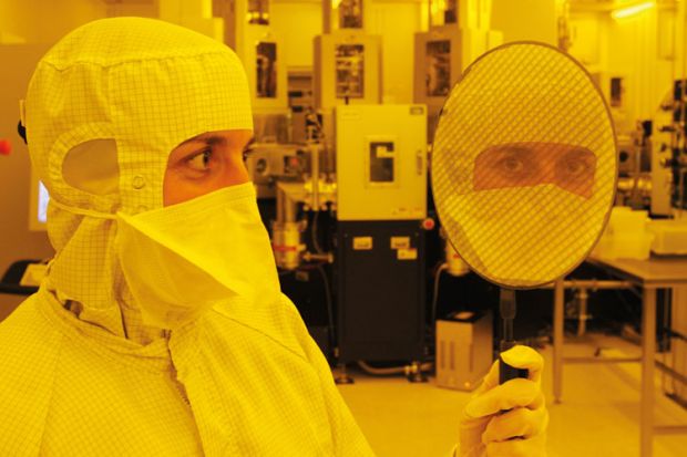 Scientist holding wafer with 667 'Eyescreens', Dresden, 2007