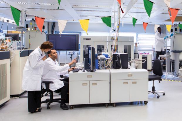 Scientists working in laboratory decorated with bunting