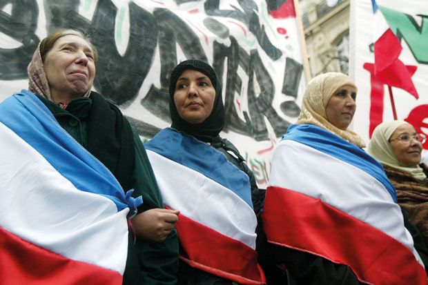 Muslim women protest against the proposal to ban headscarves in French state schools