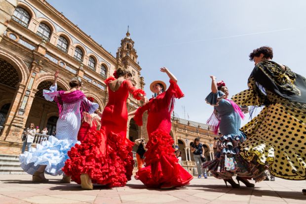 Seville, Spain - May 2017 Young women dance flamenco on Plaza de Espana during famous Feria festival