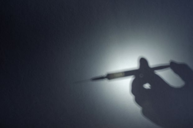 The shadow of a syringe