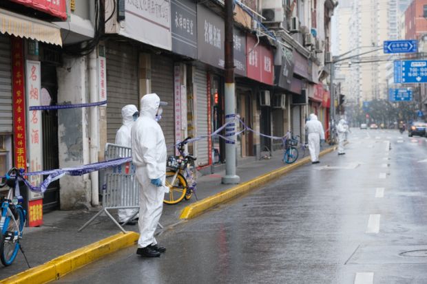 Shanghai.China-Jan.2021 new Covid-19 cases have emerged in China. Region has been locked down. Medical staff in white hazmat suit on street