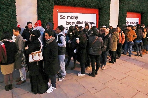 Shoppers queue outside Selfridges department store, London