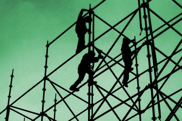 Silhouette of people building scaffolding