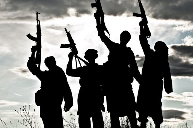 Silhouettes of Islamic terrorists aiming guns at sky