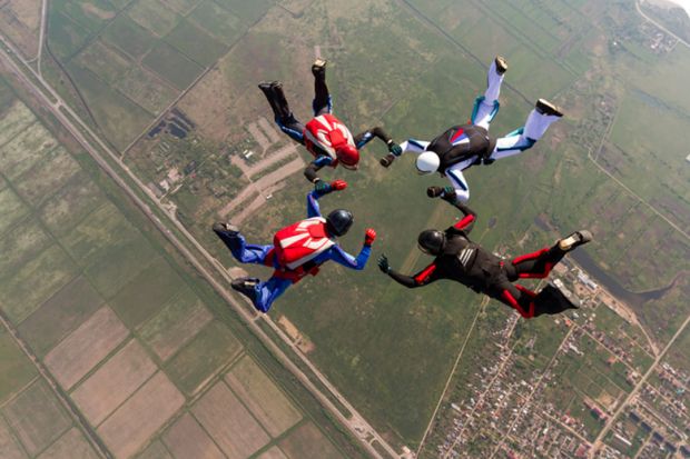 Four people skydiving 