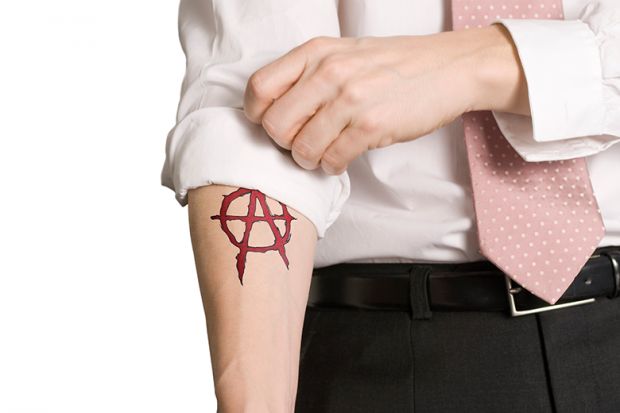 Sleeve rolled up revealing anarchist tattoo