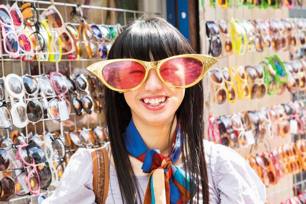 Smiling young woman wearing comedy sunglasses