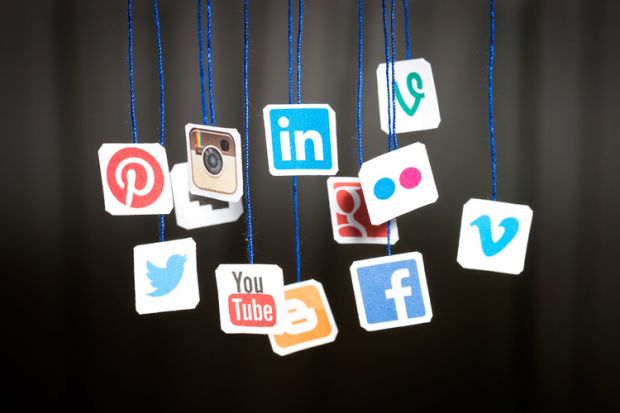 Social media icons hanging from blue string