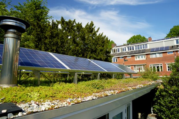 Solar panels on a sedum green rooftop garden in Helpman, Groningen