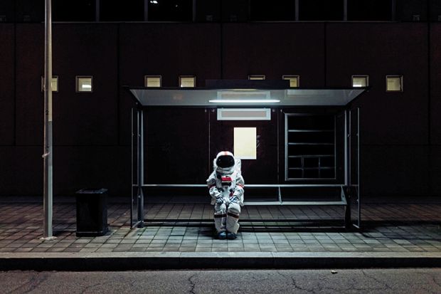 An astronaut sits at a bus stop An astronaut sits at a bus stop to illustrate being left behind