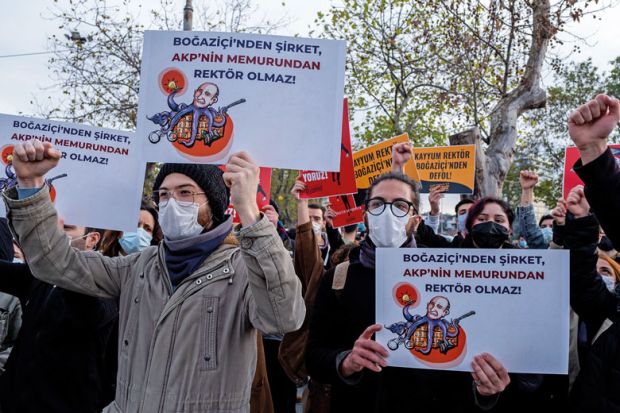 Students wearing face masks hold placards during the demonstration to illustrate Bog˘aziçi students and staff fear reprisals after deans sacked