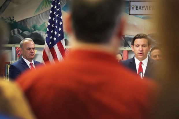Florida Gov. Ron DeSantis (R) and Florida Education Commissioner Richard Corcoran (L) attend a press conference to illustrate Florida political bias threatens presidential searches