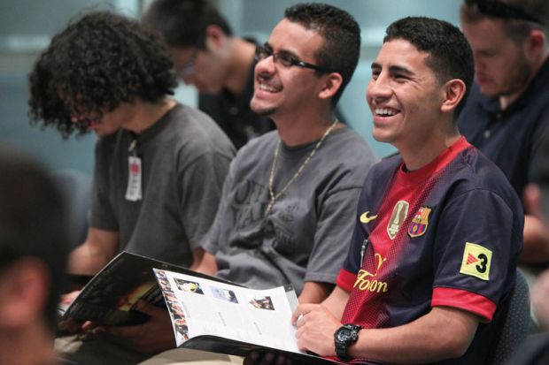 Jose Garcia, right, and Joel Hernandez laughing during a tour for engineering students from California State Polytechnic University to illustrate US Hispanics rising through higher education