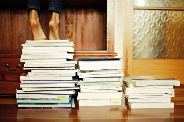 Standing on a pile of books