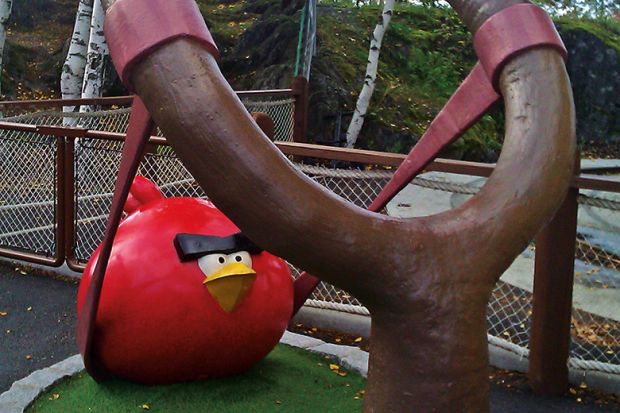 Statue of Angry Birds game character being shot from catapult