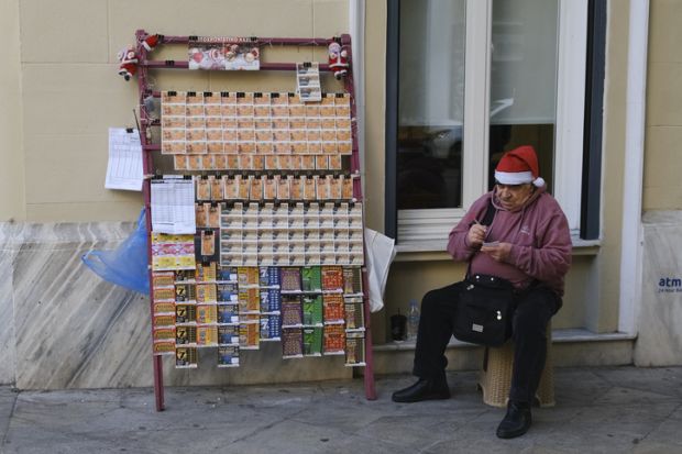 Street vendor sales lottery coupons in Athens, Greece
