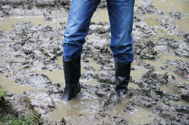 Man wearing boots stuck in the mud
