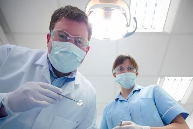 Student and dentist in dental surgery Student and dentist in dental surgery