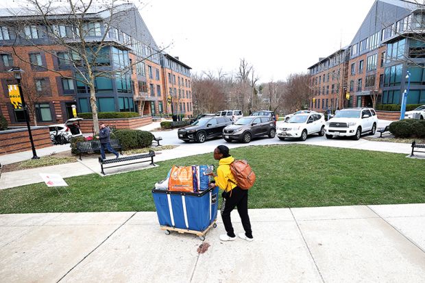 Towson University students remove their belongings from dorms