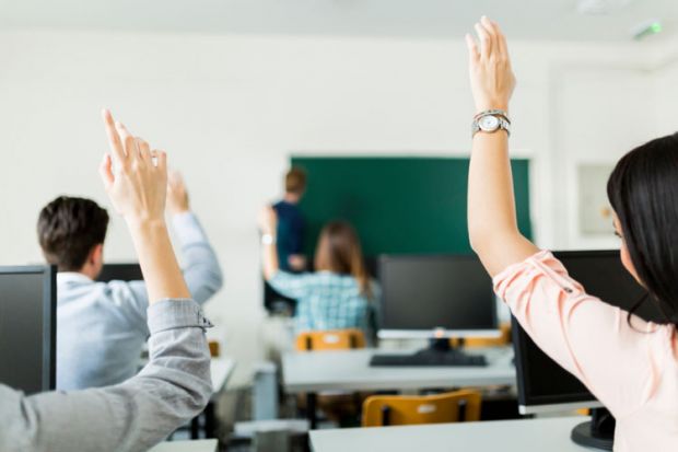 Students raising hands during lesson