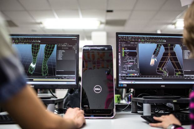 Students working with Dell desktop computers