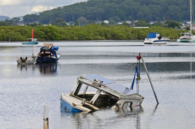 Half sunken wooden boat with just the cabin showing