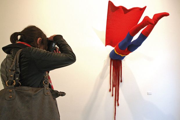 Artwork showing a superhero crashed into a wall
