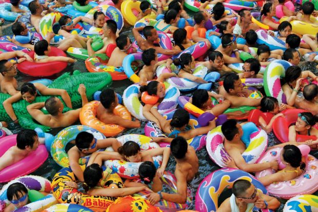 Swimmers in artificial wave pool, Suining, Sichuan province, China